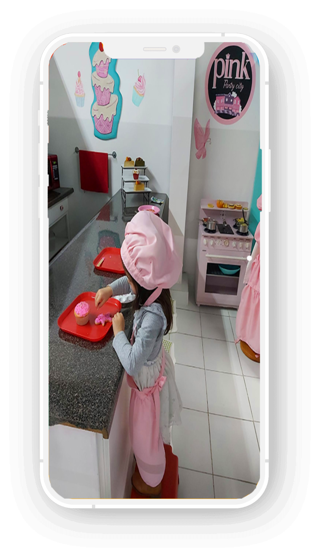 Mom enjoying photo of her daughter at Pink Party City